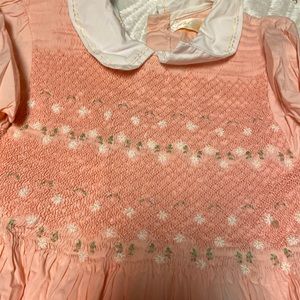 A little girls smocked dress melon and cream